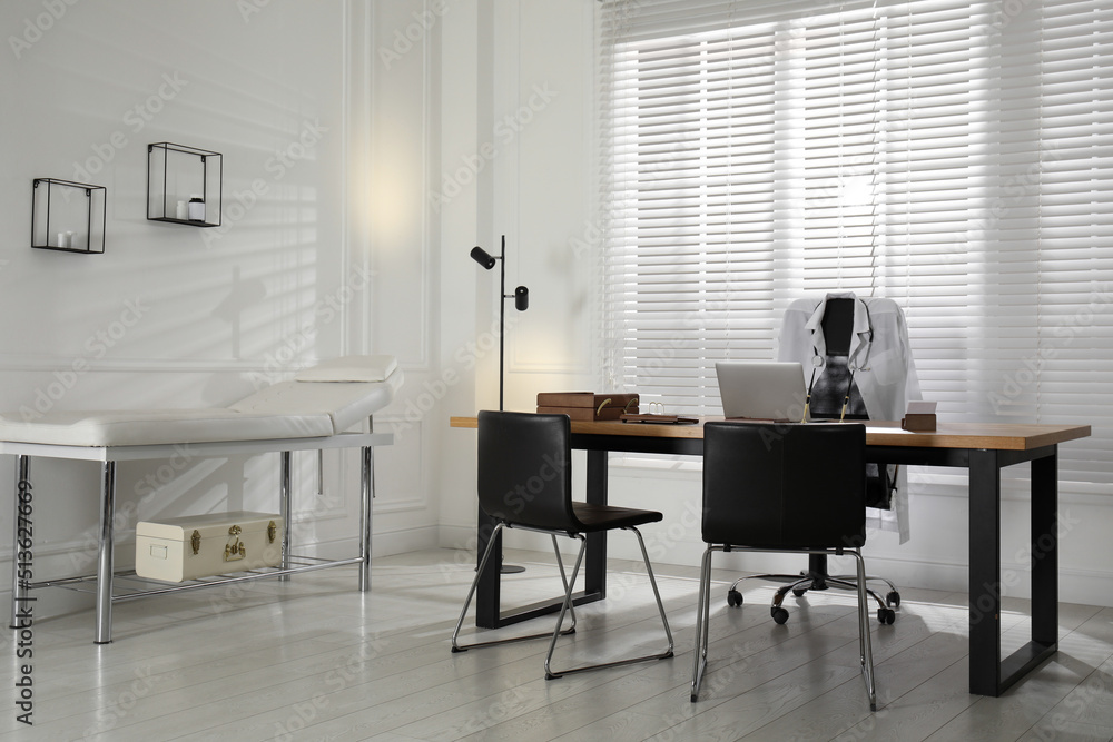 Modern medical office interior with doctor's workplace and examination table Modern medical office interior with doctor's workplace and examination table