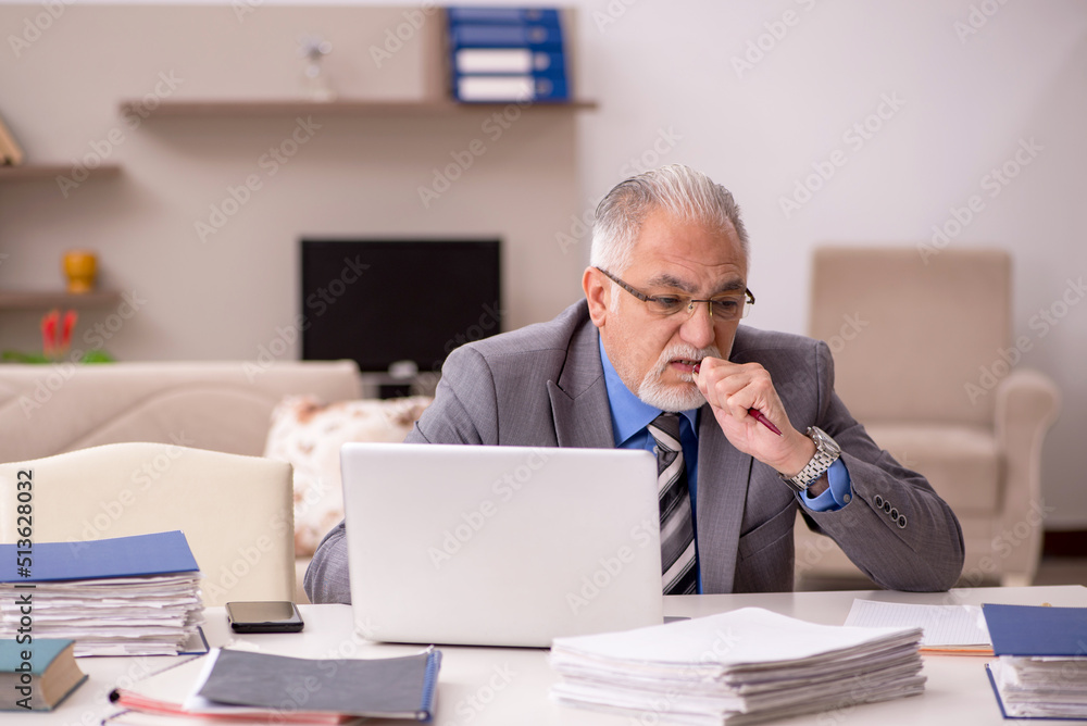 Old male employee working from home during pandemic Old male employee working from home during pandemic