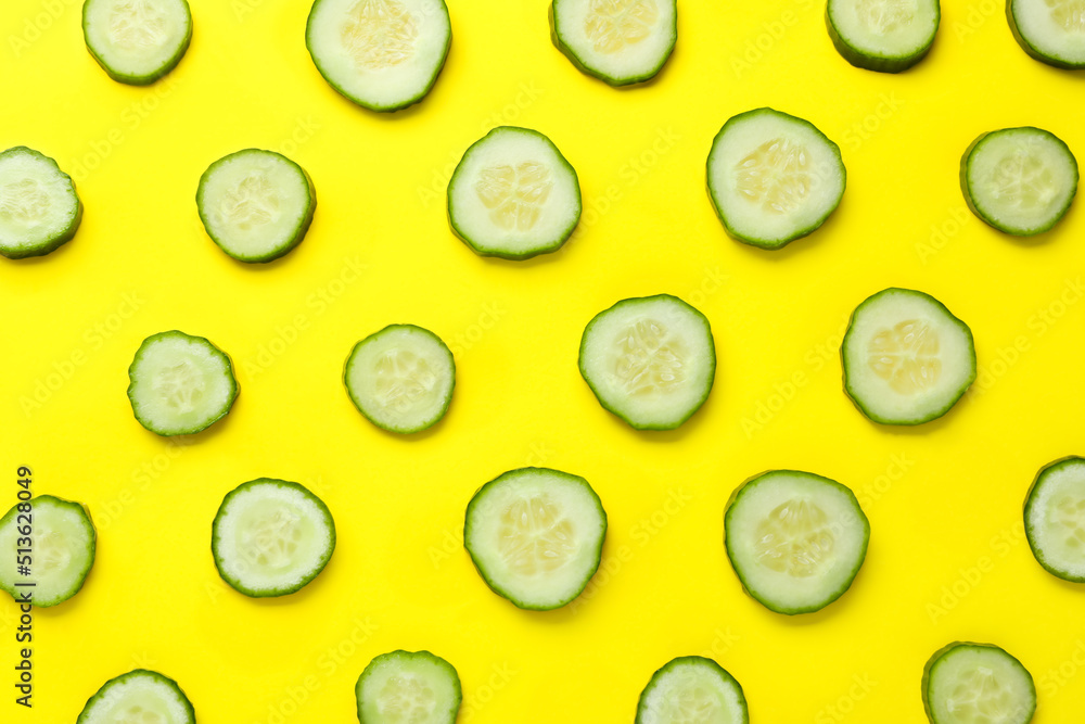 Slices of fresh ripe cucumber on yellow background, flat lay Slices of fresh ripe cucumber on yellow background, flat lay