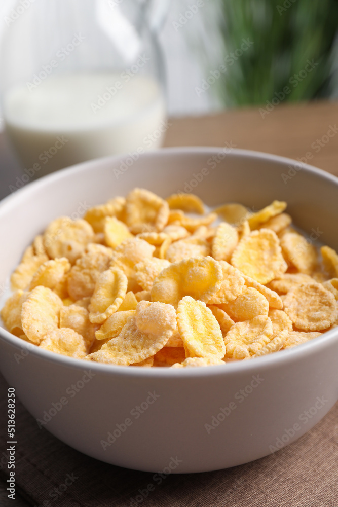 Tasty cornflakes with milk in bowl on table, closeup Tasty cornflakes with milk in bowl on table, closeup