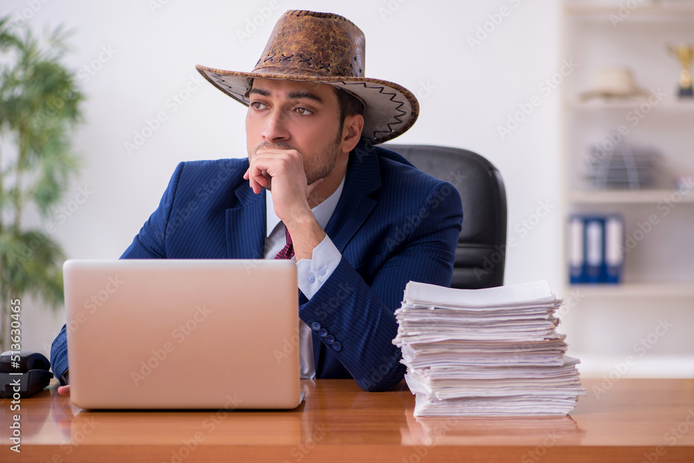 Young cowboy businessman working at workplace Young cowboy businessman working at workplace