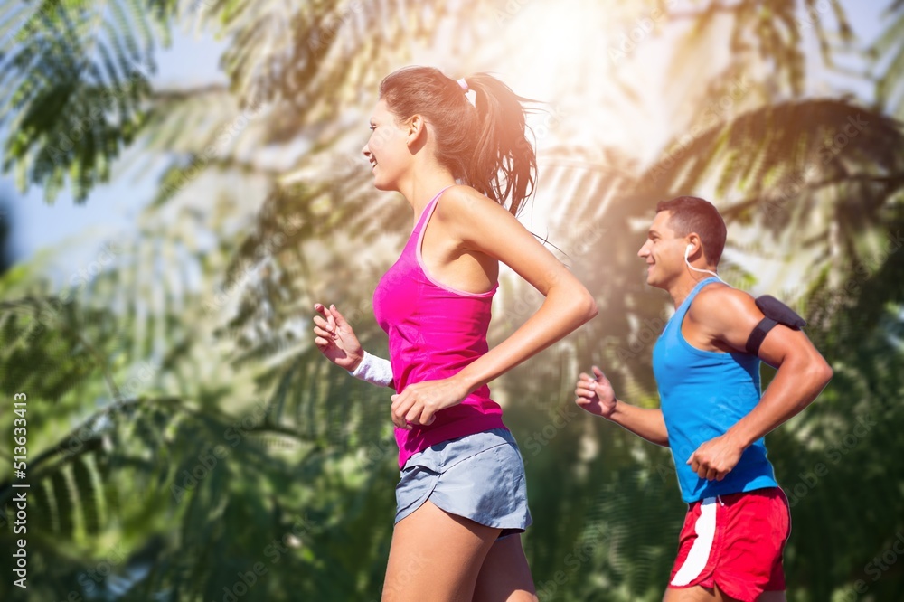 Happy slim woman wearing sportswear jogging in the city. Workout exercise in the morning. Healthy and active lifestyle concept. Happy slim woman wearing sportswear jogging in the city. Workout exercise in the morning. Healthy and active lifestyle concept.