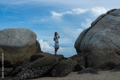 person watching the sea. person on the rock. © VIEWFOTO STUDIO