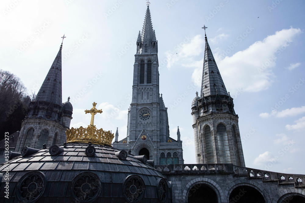 Gold Crown on dome with 3 towers in background at Sanctuary of Our Lady of Lourdes in France Gold Crown on dome with 3 towers in background at Sanctuary of Our Lady of Lourdes in France