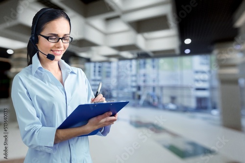 Operator of hot line. Portrait of friendly customer service representative wearing headset in call center