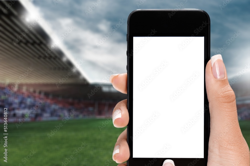 Smartphone with a blank screen on a football stadium