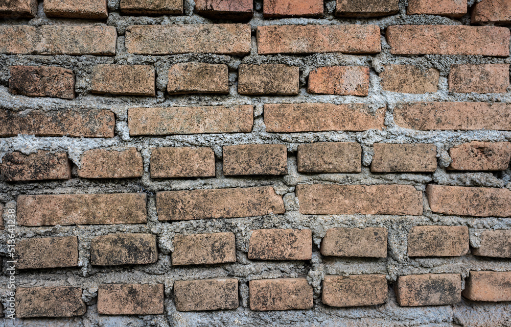 An old brick wall textured and pattern for background usage as a backdrop design. An old brick wall textured and pattern for background usage as a backdrop design.