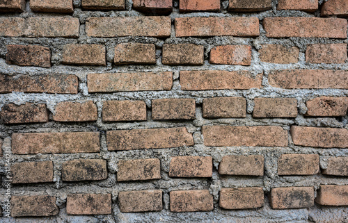 An old brick wall textured and pattern for background usage as a backdrop design.