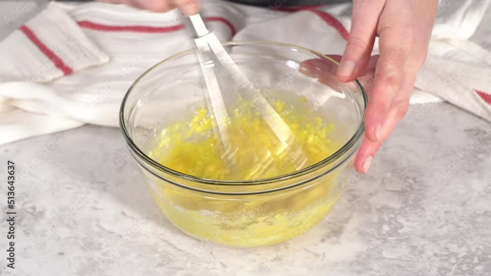 Time lapse. Step by step. Mixing ingredients in a glass mixing bowl to prepare chocolate mug cakes. Time lapse. Step by step. Mixing ingredients in a glass mixing bowl to prepare chocolate mug cakes.