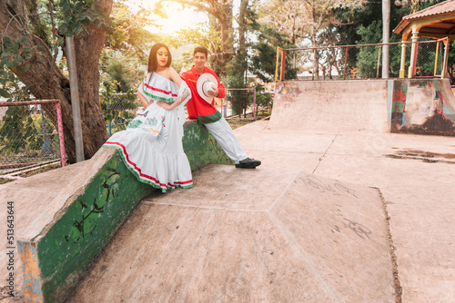 Teenager with classic Nicaraguan clothing flirting with a young woman in a public park in Jinotega Nicaragua photo