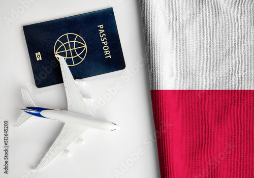 Flag of Poland with passport and toy airplane. Flight travel concept
 photo