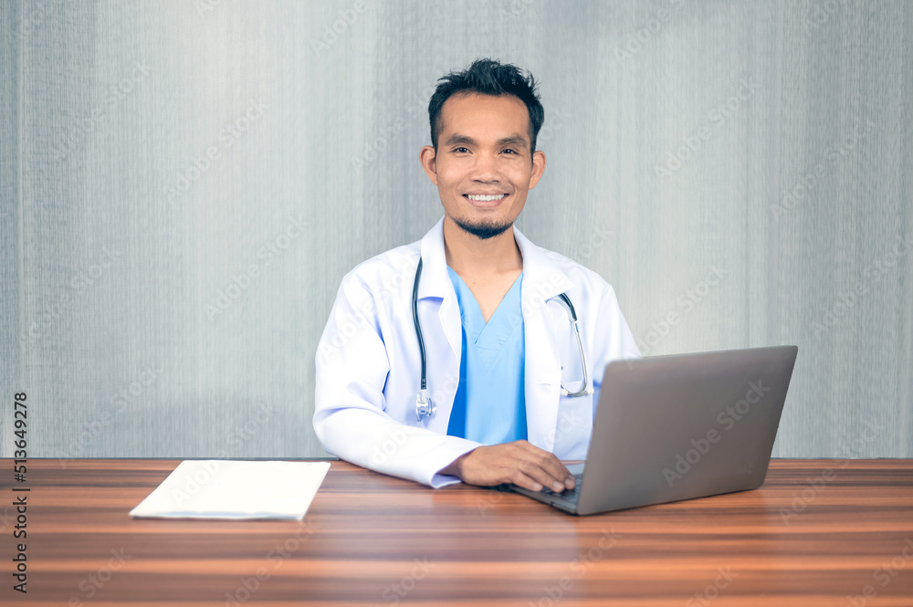 Asian doctor working laptop computer in office at hospital, Consulting and therapy concept. Asian doctor working laptop computer in office at hospital, Consulting and therapy concept.