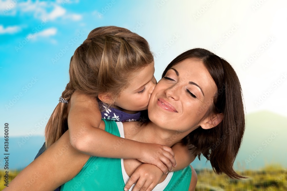 Mother's Love Concept. Portrait of happy young mom cuddling her cute tween daughter Mother's Love Concept. Portrait of happy young mom cuddling her cute tween daughter