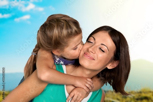 Mother s Love Concept. Portrait of happy young mom cuddling her cute tween daughter