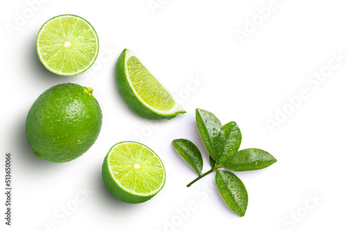 Lime fruits with green leaf and cut in half slice isolated on white background, top view, flat lay. photo