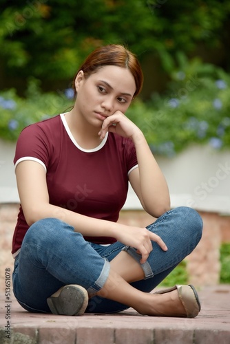 A Depressed Youthful Redhead Woman Sitting