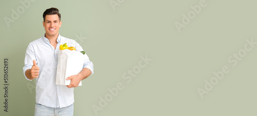 Young man with paper bag fu...