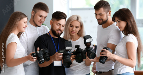 Group of young photographers during master class in studio photo