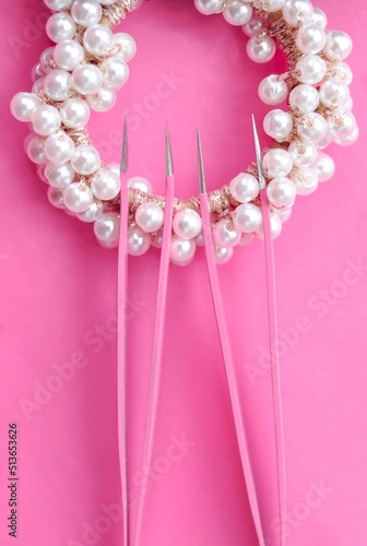 tweezers for eyelash extensions on pink background for lashmakers photo