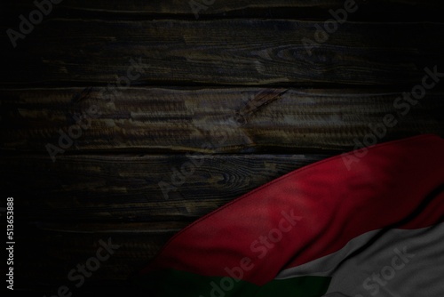 cute dark image of Sudan flag with large folds on old wood with free space for your content - any feast flag 3d illustration..