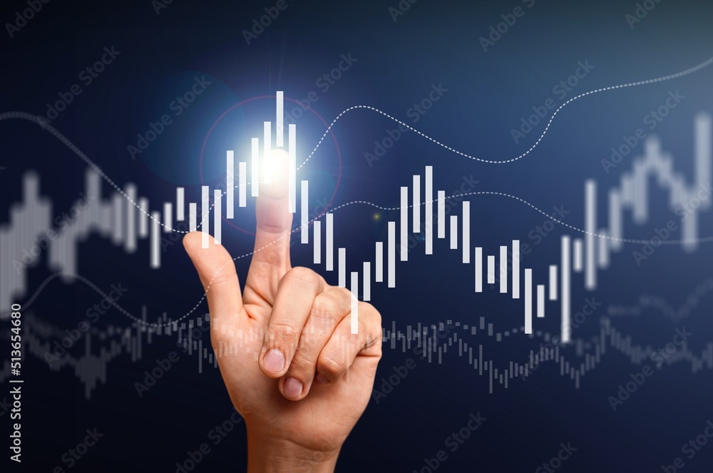 Hand pointing at business chart on blue background. Stock, market and trade concept. Hand pointing at business chart on blue background. Stock, market and trade concept.