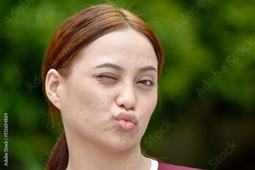 An Attractive Filipina Female Winking