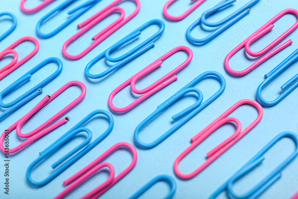 Pink and blue paper clips on color background, closeup Pink and blue paper clips on color background, closeup