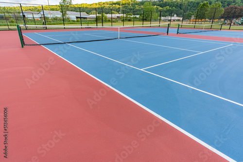 New blue tennis courts with white lines and red out of play area.  © Thomas