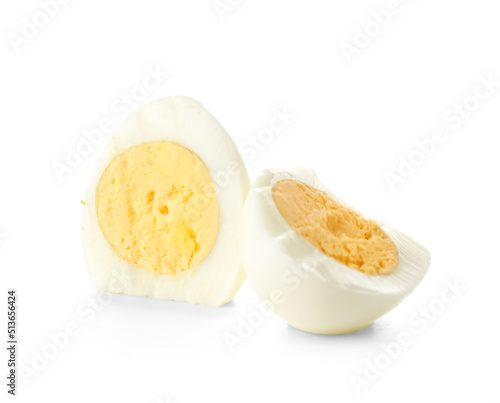 Halves of boiled chicken egg on white background