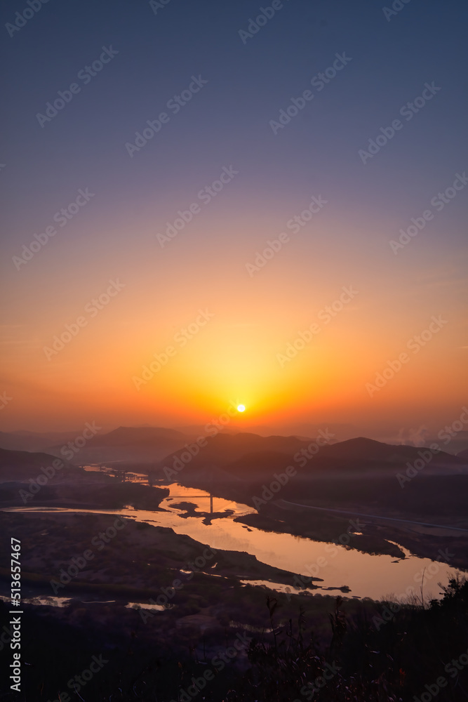 Scenic view of mountains against sky during sunrise Scenic view of mountains against sky during sunrise