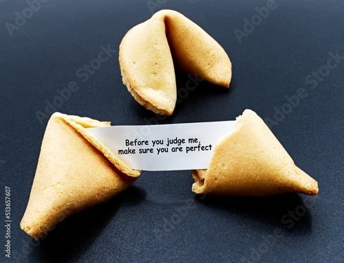 Before you judge me, make sure you are perfect. Cracked chinese fortune cookie with motivational message.