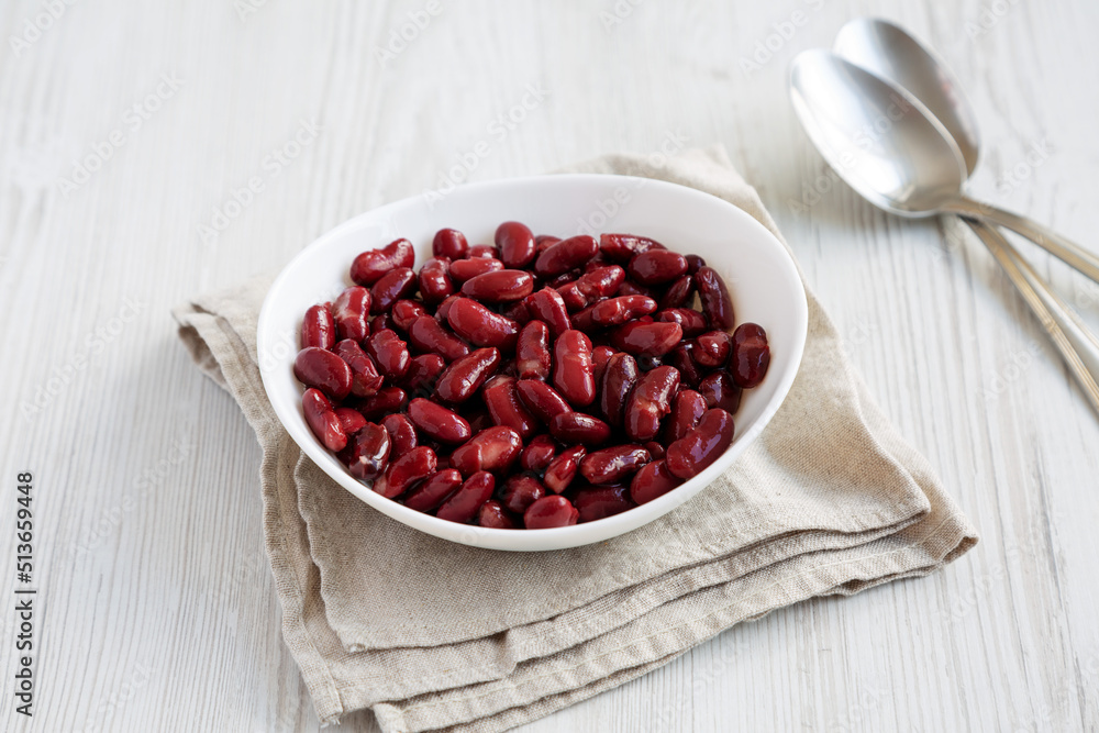 Red Organic Kidney Beans in a White Bowl on a white wooden background, top view. Flat lay, overhead, from above. Red Organic Kidney Beans in a White Bowl on a white wooden background, top view. Flat lay, overhead, from above.