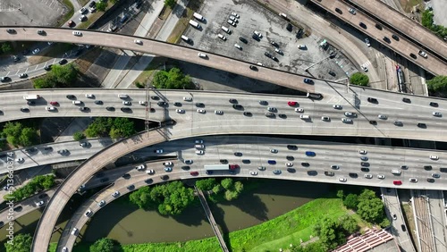 Traffic in major metropolis in America. Cars driving on USA freeway system during rush hour. Top down aerial.