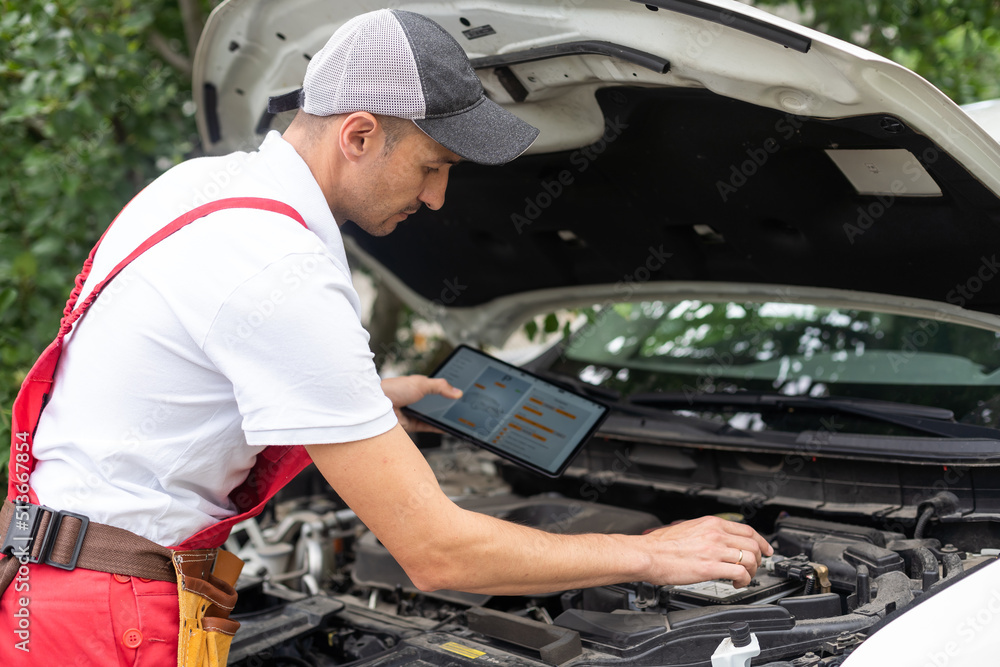 mechanic using digital tablet in workshop mechanic using digital tablet in workshop