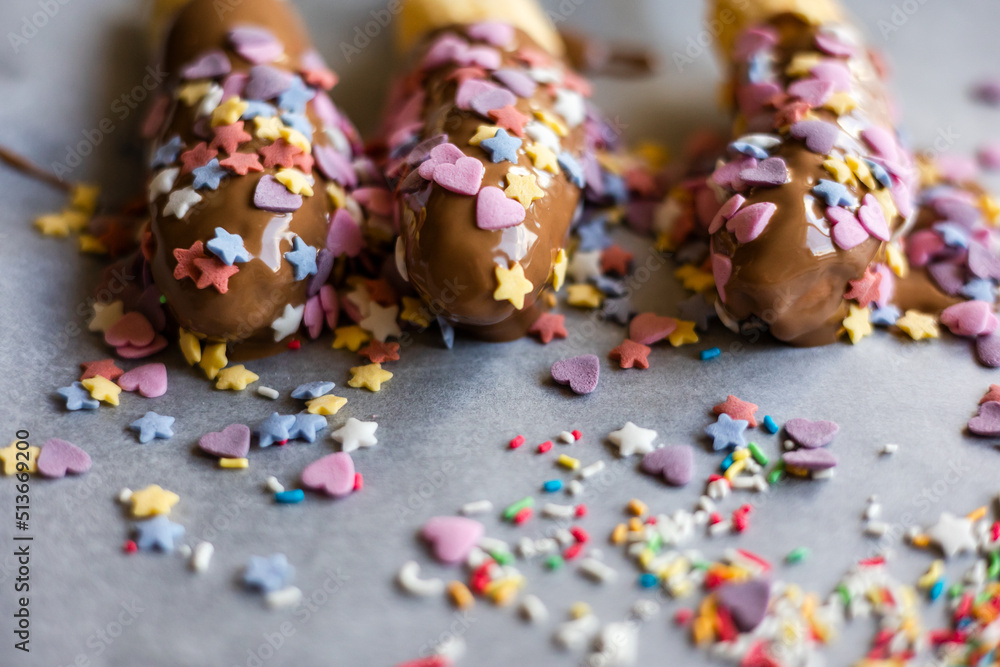 banana with chocolate and sprinkles close up banana with chocolate and sprinkles close up