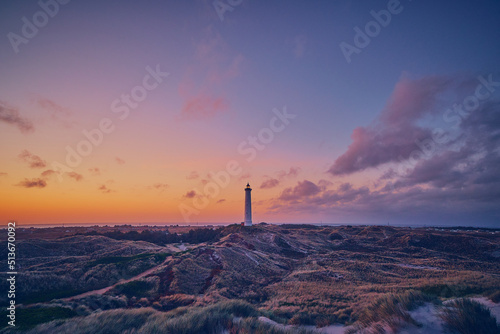 Canvas-taulu white Lighthouse at sunrise in the dunes of the danish north sea coast