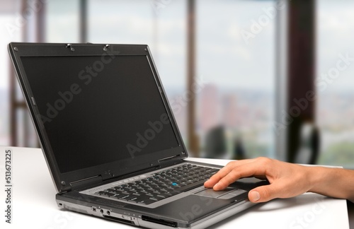 Hands are typing on a laptop keyboard, works, develops a business, studies, plays a computer game