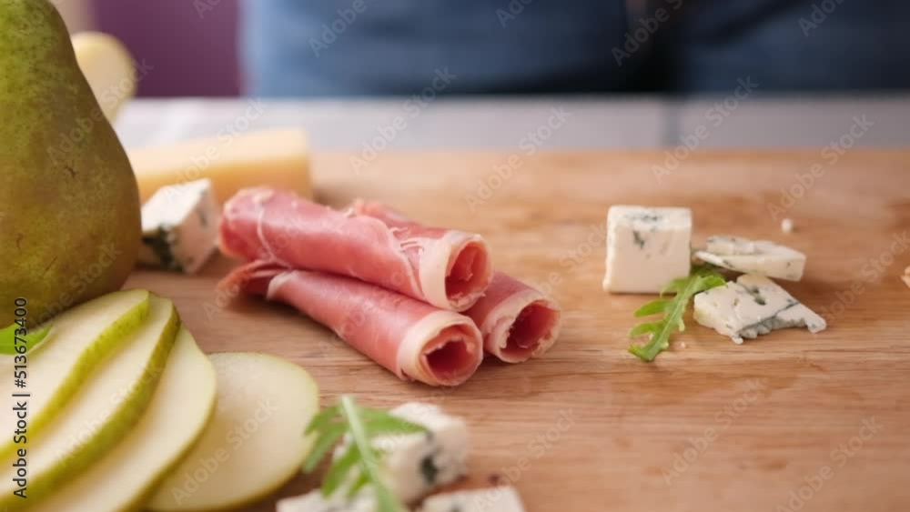 Making pear and blue cheese salad - slices of jamon Making pear and blue cheese salad - slices of jamon