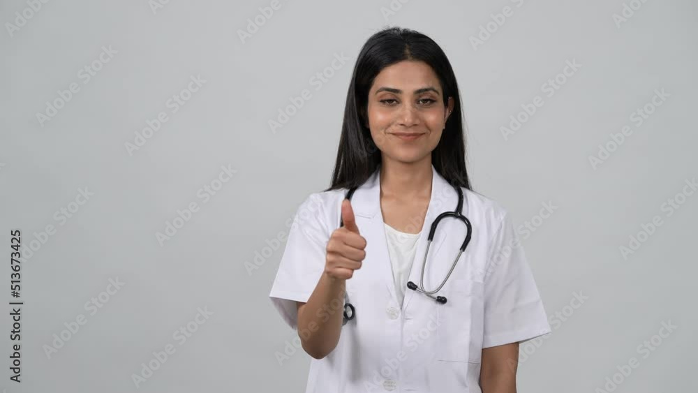 Happy young Indian woman doctor wearing white medical coat and ...