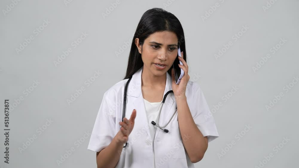 Happy young Indian woman doctor wearing white medical coat and ...