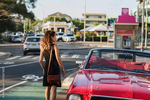 woman getting into classic car photo