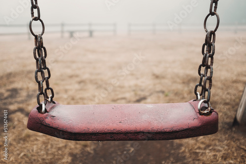 Canvas Print Scary empty swing at the park with fog in backgroind