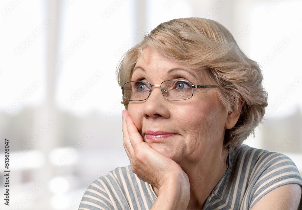 Thoughtful bored older woman looking at window, feeling depressed, frustrated, lonely, suffering form memory loss, dementia Thoughtful bored older woman looking at window, feeling depressed, frustrated, lonely, suffering form memory loss, dementia