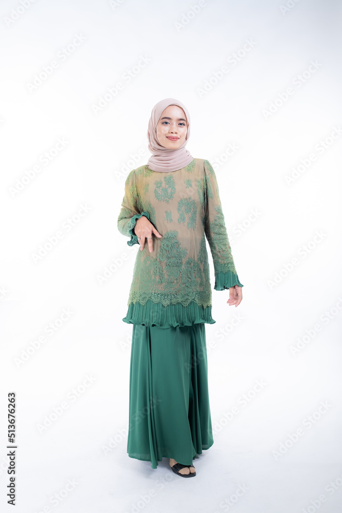 Beautiful female model in poses wearing traditional apparel and hijab, an urban lifestyle look for Muslim women isolated on white background. Beauty and hijab fashion concept. Full length Beautiful female model in poses wearing traditional apparel and hijab, an urban lifestyle look for Muslim women isolated on white background. Beauty and hijab fashion concept. Full length