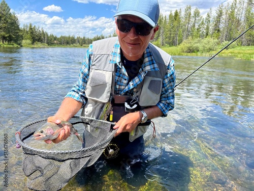 catch of a beautiful rainbow trout by a fly fisherman in Montana