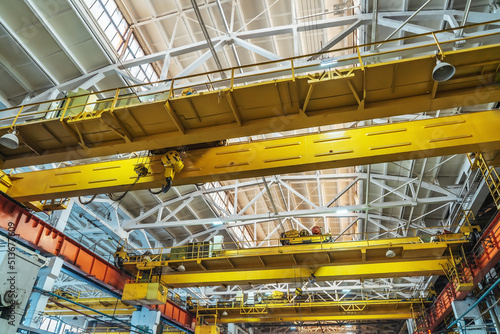 Beam cranes inside an industrial metal manufacturing plant. photo