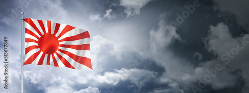 Japanese naval ensign flag on a cloudy sky photo