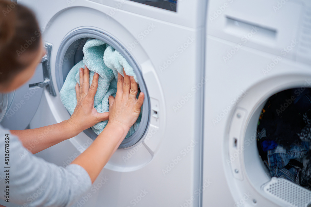 Picture of young woman making laundry work Picture of young woman making laundry work