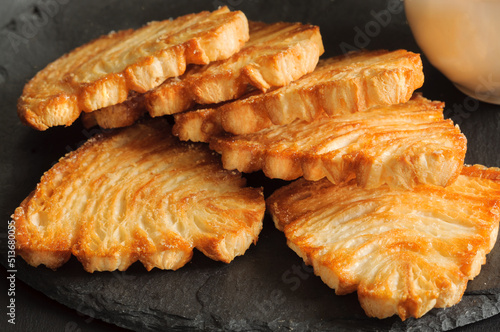 Puff pastry fan close-up on black slate in natural light. selective focus