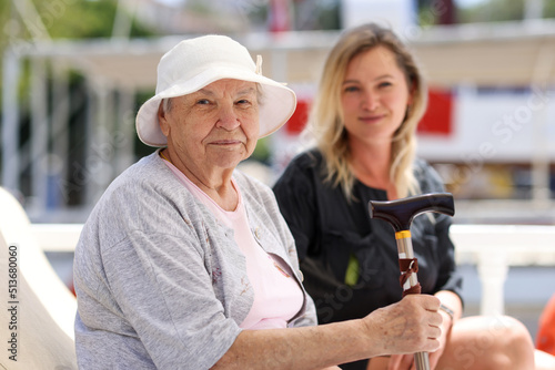 Senior woman with guardian on walk in summer